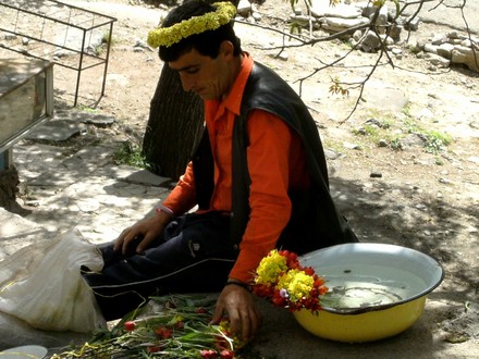 Armenian man making garlands and posies from local wild flowers that grow in this mountainous area.