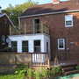 Back of the house and deck-side bed