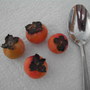 Persimmons with spoon to show size